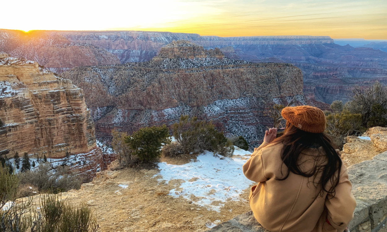 Girl looking at the Grand Canyon in winter