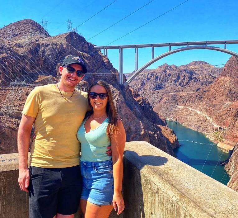 Couple posing in front of the Hoover Dam