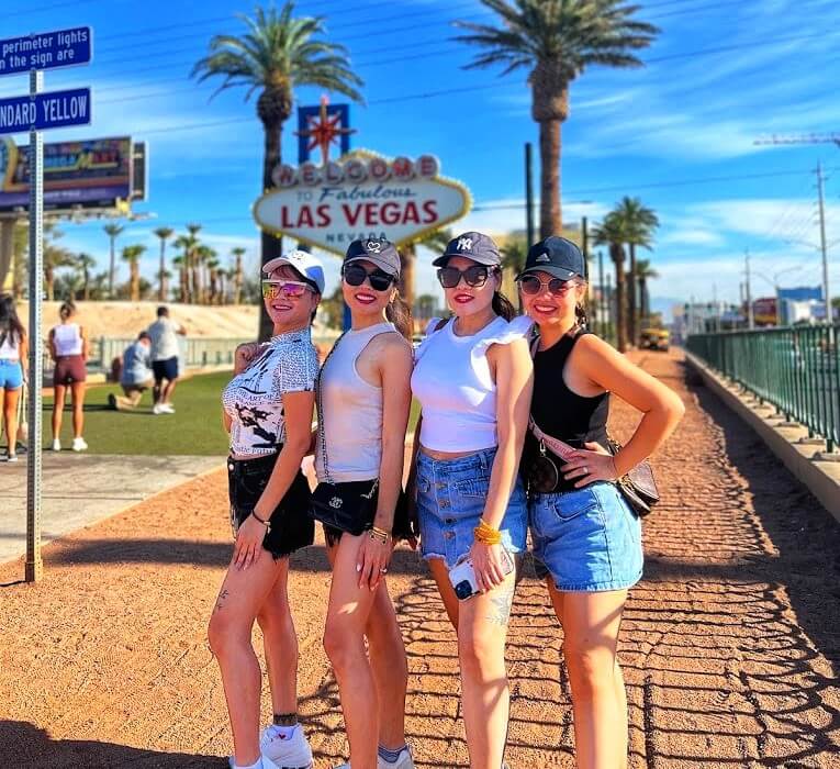 4 ladies posing in front of the Welcome to Las Vegas sign