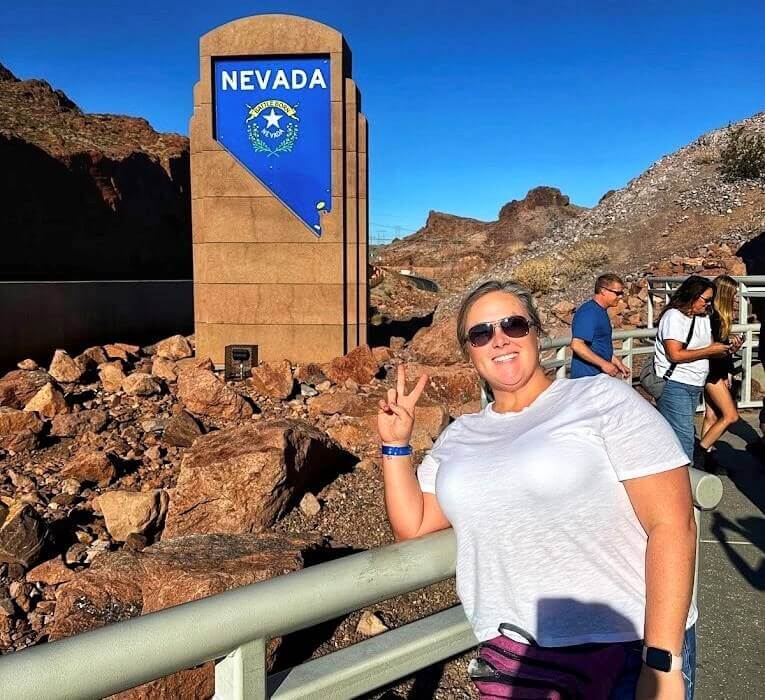Photo in front of Nevada state sign at the Hoover Dam