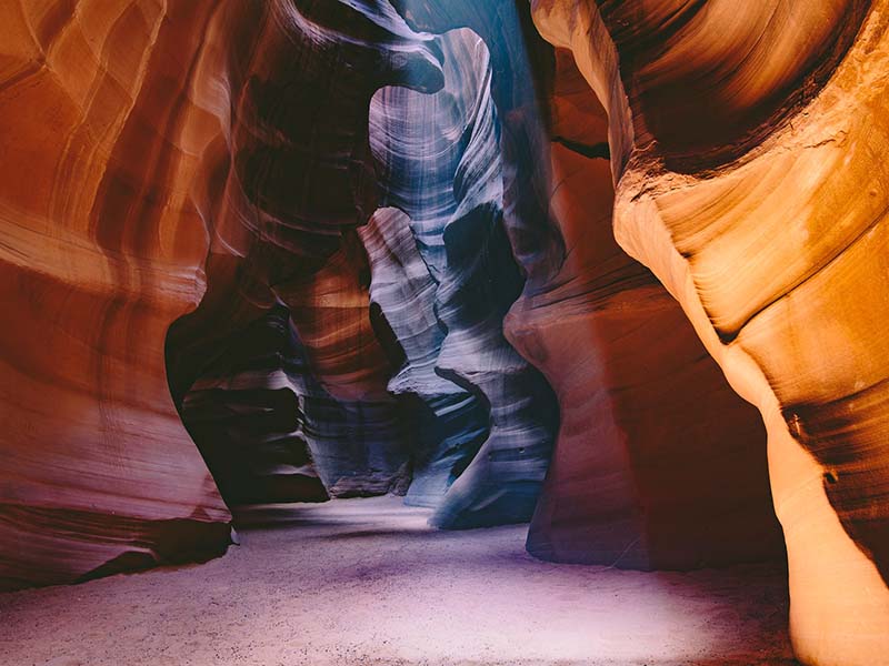 A view of Antelope Canyon, with the walls ranging in color from orange to indigo