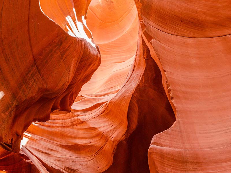 A close up of curved, orange rock walls at Antelope Canyon