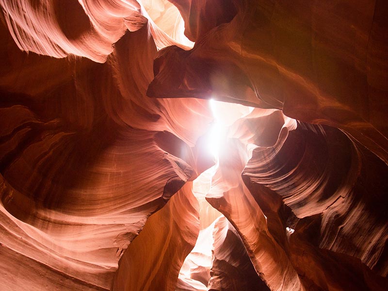 A close up of the walls of Antelope Canyon with light shining down between them
