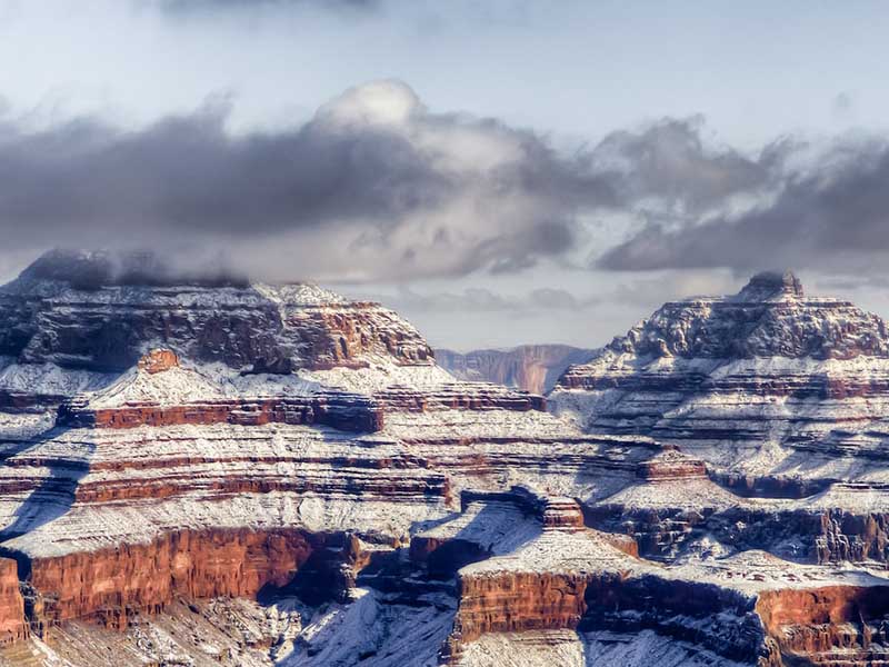 Red rock formations covered by snow at the Grand Canyon